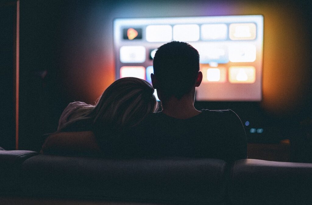 A couple watching TV.