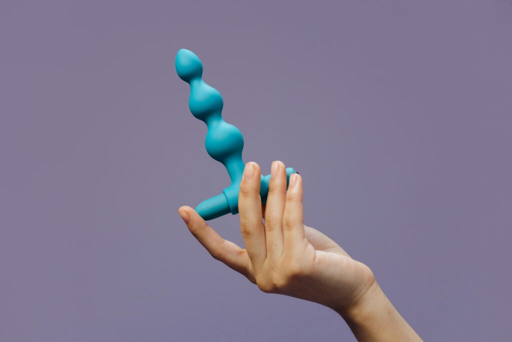 A blue sex toy with multiple bumps